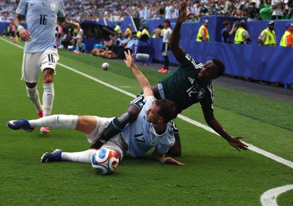(260616) -- MIAMI, June 16, 2026 -- Saud Abdullhamid (top) of Saudi Arabia and Matias Vina (bottom) of Uruguay compete during the group H match between Saudi Arabia and Uruguay at the 2026 FIFA World Cup, WM, Weltmeisterschaft, Fussball at Miami Stadium, Miami, the United States, June 15, 2026. ) (SP)U.S.-MIAMI-FOOTBALL-FIFA WORLD CUP-GROUP H-KSA VS URU XuxZijian 