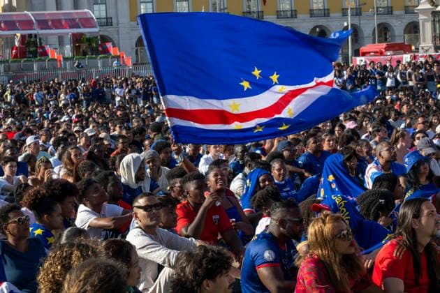 June 15, 2026, Lisbon, Portugal: A fan of Cape Verde national soccer team is seen waving a flag during a live broadcast of the soccer match held at Praca do ComÃ rcio in Lisbon. FIFA World Cup, WM, Weltmeisterschaft, Fussball is the most important and widely watched sporting event on the planet. It is held every four years and brings together the best national soccer teams, which qualify through elimination tournaments in their respective continental confederations. Lisbon Portugal - ZUMAs197 0859236284st Copyright: xJorgexCastellanosx