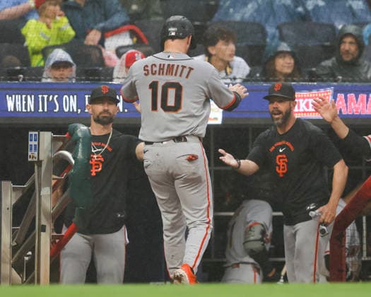 Left fielder Casey Schmitt 10 of the San Francisco Giants shakes hands with coaches after scoring in the second inning against the Atlanta Braves at Truist Park on Tuesday, June 16, 2026 in Atlanta, Georgia.  ATL20260616110 MikexZarrilli