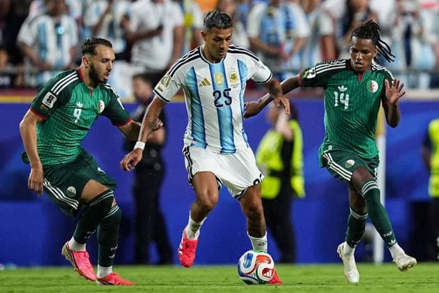 Facundo Medina of Argentina pressured by Amine Gouiri of Algeria and Hicham Boudaoui of Algeria Argentina v Algeria, 2026 FIFA World Cup, WM, Weltmeisterschaft, Fussball Group J, Football, Kansas City Stadium, Kansas, Missouri, USA - 16 Jun 2026Kansas Kansas City Stadium Missouri (MO) United States of America EDITORIAL USE ONLY No use with unauthorised audio, video, data, fixture lists, club league logos or live services. Online in-match use limited to 120 images, no video emulation. No use in betting, games or single club league player publications.  Copyright: xIsmaelxAdnan Shutterstockx 16929214dg