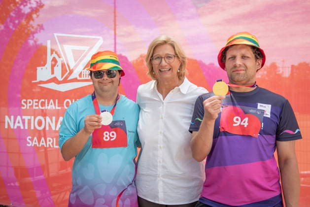 17.06.2026, Saarland, Saarbrücken. Ministerpräsidentin Anke Rehlinger besucht am Mittwoch die Leichtathletikwettkämpfe der Special Olympics im Stadion am Kieselhumes hier mit den AWO Medaillengewinnern Emre Atilgan (li.) und Pierre Verwaayen (re.)
