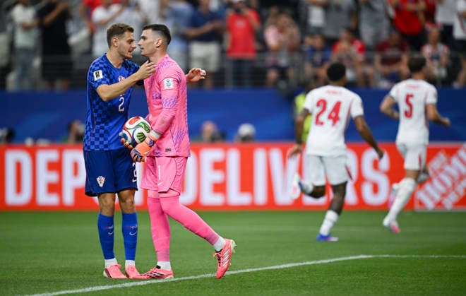 (260618) -- DALLAS, June 18, 2026 -- Josip Stanisic (L) of Croatia hugs their goalkeeper Dominik Livakovic after the latter failed to save a goal during the group L match between England and Croatia at the 2026 FIFA World Cup, WM, Weltmeisterschaft, Fussball at the Dallas Stadium in Dallas, the United States, on June 17, 2026. ) (SP)U.S.-DALLAS-FOOTBALL-FIFA WORLD CUP-GROUP L-ENG VS CRO WuxXiaoling 