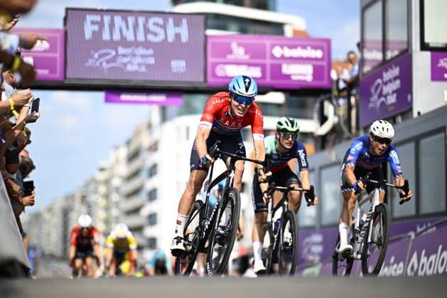 Belgian Tim Merlier of Soudal Quick-Step and Belgian Jasper Philipsen of Alpecin-Premier Tech cross the finish line of stage 2 of the Baloise Belgium Tour cycling race, 197,6 km from Merelbeke-Melle to Knokke-Heist, Thursday 18 June 2026. The Baloise Belgium Tour takes place from 17 to 21 June. JASPERxJACOBS  x178088705x