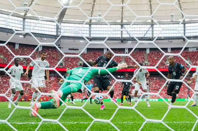 FIFA World Cup, WM, Weltmeisterschaft, Fussball 2026 - Group B - Canada vs Qatar Canada forward Cyle Larin scores past Qatar goalkeeper Mahmud Abunada as teammate Derek Cornelius looks on during the FIFA World Cup 2026 group stage match between Canada and Qatar in Vancouver, Canada, 18 June 2026. VANCOUVER Canada  Copyright: xBOBxFRIDx