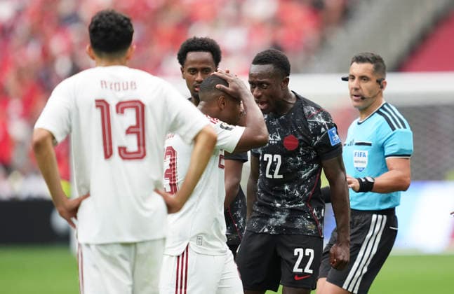 (260619) -- VANCOUVER, June 19, 2026 -- Richie Laryea (2nd R) of Canada shouts at Assim Madibo (C) of Qatar for the injury of Canada s Ismael Kone during the group B match between Canada and Qatar at the 2026 FIFA World Cup, WM, Weltmeisterschaft, Fussball at BC Place Vancouver in Vancouver, Canada, June 18, 2026. ) (SP)CANADA-VANCOUVER-FOOTBALL-FIFA WORLD CUP-GROUP B-CAN VS QAT MengxYongmin 