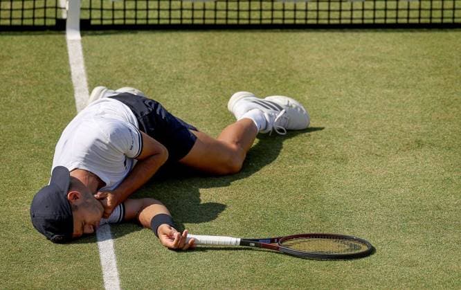Francisco Cerundolo of Argentina lies on the grass clutching his throat having been hit by Arthur Fery of GB HSBC Queen s Club Championships, Day Fourteen, Tennis, Queen s Club, West Kensington, London, UK - 19 Jun 2026London Queen s Club United Kingdom  Copyright: xEllaxLing Shutterstockx 16929306as