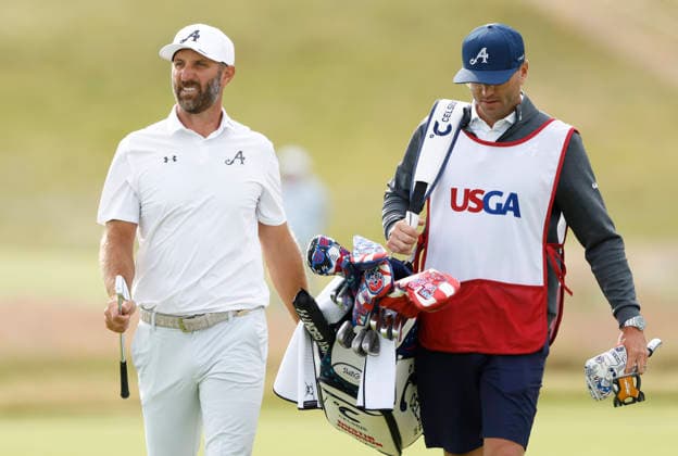 Dustin Johnson and his caddie walk to the 1st green during the second round of the 126th U.S. Open Golf Championship at Shinnecock Hills Golf Club in Southampton, NY, on Friday, June 19, 2026.  NYC20260619802 JOHNxANGELILLO