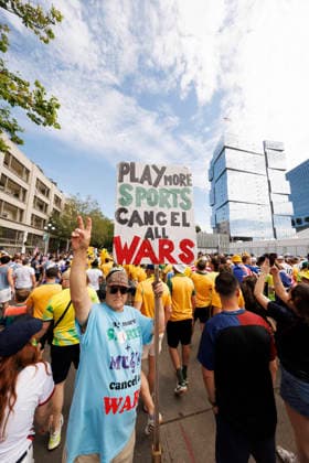 SEATTLE, WASHINGTON - JUNE 19: A spectator holds a sign saying Play more sports cancel all wars outside the stadium before the FIFA World Cup, WM, Weltmeisterschaft, Fussball 2026 Group D match between USA and Australia at Seattle Stadium on June 19, 2026 in Seattle, Washington.  Copyright: xMBxMediax