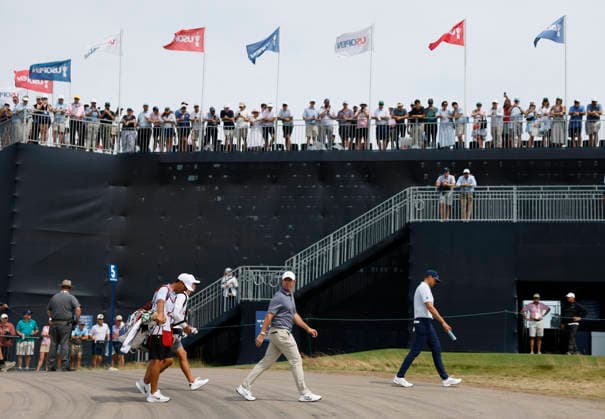 Spectators watch as Rory McIlroy of Northern Ireland walks to the 5th tee box in the second round of the 126th U.S. Open Golf Championship at Shinnecock Hills Golf Club in Southampton, NY on Friday, June 19, 2026.  NYC202606191010 JOHNxANGELILLO
