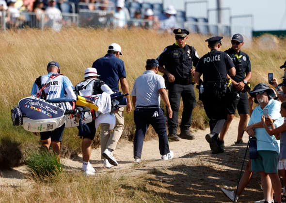 Police protection and security lead the way for Scottie Scheffler and J. J. Spaun who walk off of the 18th green in the second round of the 126th U.S. Open Golf Championship at Shinnecock Hills Golf Club in Southampton, NY on Friday, June 19, 2026.  NYC202606191028 JOHNxANGELILLO