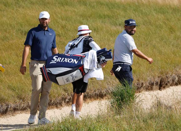Scottie Scheffler and J. J. Spaun look back as they walk off of the 18th green in the second round of the 126th U.S. Open Golf Championship at Shinnecock Hills Golf Club in Southampton, NY on Friday, June 19, 2026.  NYC202606191029 JOHNxANGELILLO