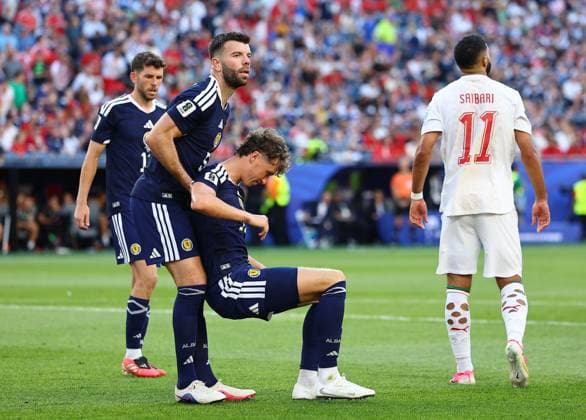 Grant Hanley of Scotland helping Jack Hendry of Scotland stand up Scotland v Morocco, 2026 FIFA World Cup, WM, Weltmeisterschaft, Fussball Group C, Football, Boston Stadium, Foxborough, Massachusetts, USA - 19 Jun 2026Foxborough Boston Stadium Massachusetts (MA) United States of America EDITORIAL USE ONLY No use with unauthorised audio, video, data, fixture lists, club league logos or live services. Online in-match use limited to 120 images, no video emulation. No use in betting, games or single club league player publications.  Copyright: xMichaelxZemanek Shutterstockx 16928953fm
