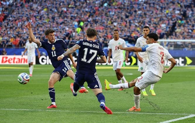 Achraf Hakimi of Morocco has a shot despite the attentions of Ryan Christie of Scotland and Ben Gannon-Doak of Scotland Scotland v Morocco, 2026 FIFA World Cup, WM, Weltmeisterschaft, Fussball Group C, Football, Boston Stadium, Foxborough, Massachusetts, USA - 19 Jun 2026Foxborough Boston Stadium Massachusetts (MA) United States of America EDITORIAL USE ONLY No use with unauthorised audio, video, data, fixture lists, club league logos or live services. Online in-match use limited to 120 images, no video emulation. No use in betting, games or single club league player publications.  Copyright: xMichaelxZemanek Shutterstockx 16928953fs