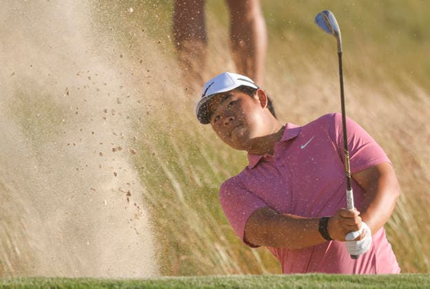 Tom Kim of South Korea chips out of a bunker to the 14th green during the third round of the 126th U.S. Open Golf Championship at Shinnecock Hills Golf Club in Southampton, NY, on Saturday, June 20, 2026.  NYC20260620816 JOHNxANGELILLO