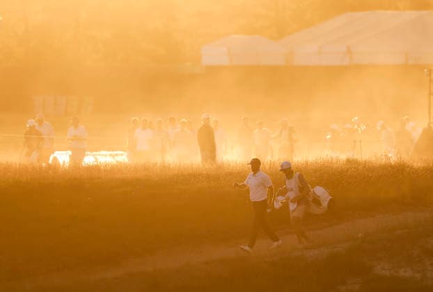 Wyndham Clark and his caddie walk to the 18th tee as the sun sets during the third round of the 126th U.S. Open Golf Championship at Shinnecock Hills Golf Club in Southampton, NY, on Saturday, June 20, 2026.  NYC20260620838 JOHNxANGELILLO