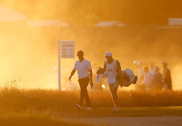 Wyndham Clark and caddie David Pelekoudas walk from the 18th tee box before sunset in the third round of the 126th U.S. Open Golf Championship at Shinnecock Hills Golf Club in Southampton, NY on Saturday, June 20, 2026.  NYC202606202024 JOHNxANGELILLO