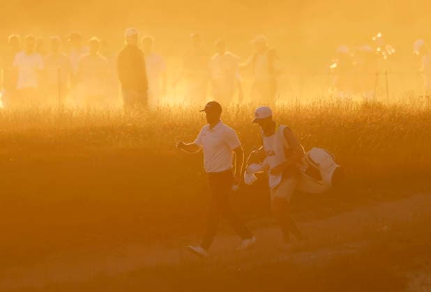 Wyndham Clark and caddie David Pelekoudas walk from the 18th tee box before sunset in the third round of the 126th U.S. Open Golf Championship at Shinnecock Hills Golf Club in Southampton, NY on Saturday, June 20, 2026.  NYC202606202026 JOHNxANGELILLO