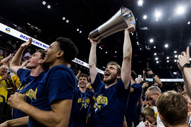 MUNICH, GERMANY - JUNE 21: Malte Delow (Alba Berlin, 6) raising the championship trophy after the easyCredit Basketball Bundesliga Playoffs Final Game 5 match between FC Bayern Muenchen vs. Alba Berlin at SAP Garden on June 21, 2026 in Munich, Germany. Bavaria Germany Copyright: xSteffiexWunderlx