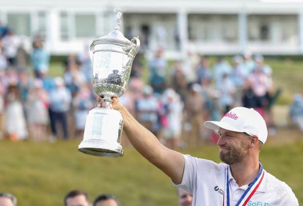 Wyndham Clark raises the trophy after winning the 126th U.S. Open Golf Championship at Shinnecock Hills Golf Club in Southampton, NY, on Sunday, June 21, 2026. Clark won with a four-under-par score of 276.  NYC20260621920 JOHNxANGELILLO