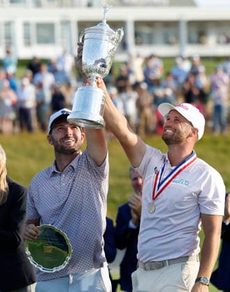 Wyndham Clark celebrates with his caddie David Pelekoudas after winning the 126th U.S. Open Golf Championship at Shinnecock Hills Golf Club in Southampton, NY, on Sunday, June 21, 2026. Clark won with a four-under-par score of 276.  NYC20260621936 JOHNxANGELILLO
