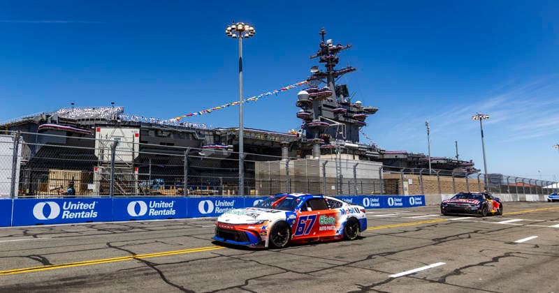 SAN DIEGO, CA - JUNE 21: Corey Heim of the 67 23XI Open MOBIL 1 O REILLY AUTO PARTS Toyota passes the USS Carl Vinson (CVN70) at turn 2 during the Anduril 250 NASCAR, Motorsport, USA Cup Series Race, Sunday, June 21, 2026, at Naval Base Coronado in San Diego, California. (Photo by Tony Ding Icon Sportswire) AUTO: JUN 21 NASCAR Cup Series Anduril 250 Race the Base EDITORIAL USE ONLY Icon46520260621026250