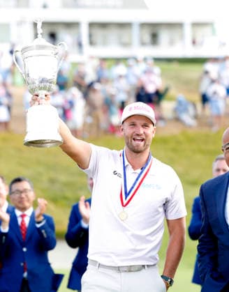 Wyndham Clark holds the championship trophy after winning the 126th U.S. Open Golf Championship at Shinnecock Hills Golf Club in Southampton, NY, on Sunday, June 21, 2026. Clark won with a four-under-par score of 276.  NYC202606213010 JOHNxANGELILLO