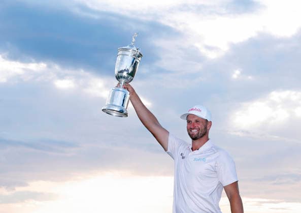 Wyndham Clark holds the championship trophy after winning the 126th U.S. Open Golf Championship at Shinnecock Hills Golf Club in Southampton, NY, on Sunday, June 21, 2026. Clark won with a four-under-par score of 276.  NYC202606213013 JOHNxANGELILLO