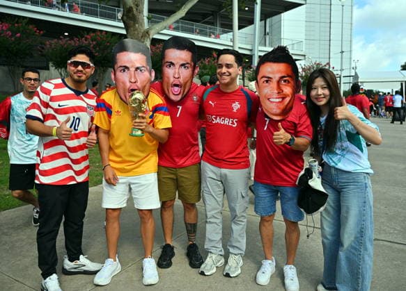 FIFA World Cup, WM, Weltmeisterschaft, Fussball 2026 - Group K - Portugal vs Uzbekistan Soccer fans pose with face masks of Cristiano Ronaldo prior the FIFA World Cup 2026 group stage match Portugal against Uzbekistan, in Houston, USA, 23 June 2026. HOUSTON United States  Copyright: xSAMxWASSONx