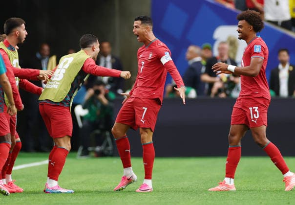 Portugal s Cristiano Ronaldo celebrates with teammates after scoring a goal against Uzbekistan in the first half of a FIFA World Cup, WM, Weltmeisterschaft, Fussball match at Houston Stadium in Houston, Texas, on Tuesday, June 23, 2026.  HOU20260623909 CHRISTIANxBRUNSKILL