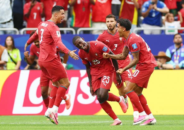 Portugal s Nuno Mendes (25) celebrates with teammates after scoring on a free kick against Uzbekistan in the first half at Houston Stadium in Houston, Texas, on Tuesday, June 23, 2026.  HOU20260623919 CHRISTIANxBRUNSKILL
