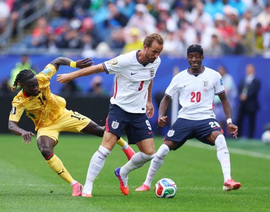 Foxborough, USA, 23rd June 2026. Gideon Mensah of Ghana tussles with Harry Kane of England during the England vs Ghana FIFA World Cup, WM, Weltmeisterschaft, Fussball match at Gillette Stadium, Foxborough. Picture credit should read: Paul Terry Sportimage EDITORIAL USE ONLY. No use with unauthorised audio, video, data, fixture lists, club league logos or live services. Online in-match use limited to 120 images, no video emulation. No use in betting, games or single club league player publications. SPI_060_PT_Eng_Ghana SPI-4840-0067