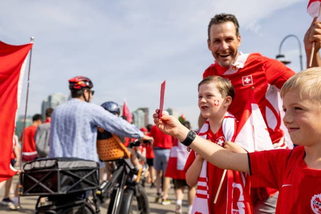 June 24, 2026, Vancouver, Bc, CANADA: A young Canadian soccer fan shows a red card to a group of Switzerland fans as they march toward B.C. Place before a World Cup Group B soccer match against Canada, in Vancouver, on Wednesday, June 24, 2026. Canada News - June 24, 2026  - ZUMAc35_ 20260624_zaf_c35_052 Copyright: xTimothyxMatweyx