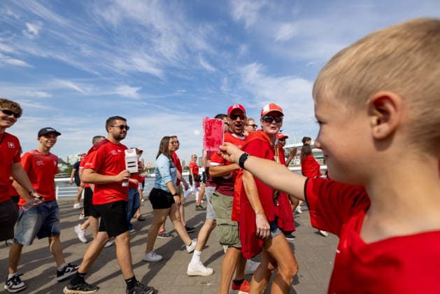 June 24, 2026, Vancouver, Bc, CANADA: A young Canadian soccer fan shows a red card to a group of Switzerland fans as they march toward B.C. Place before a World Cup Group B soccer match against Canada, in Vancouver, on Wednesday, June 24, 2026. Canada News - June 24, 2026  - ZUMAc35_ 20260624_zaf_c35_053 Copyright: xTimothyxMatweyx