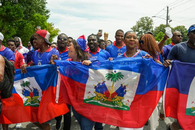 June 24, 2026, Atlanta, Georgia, United States of America: Haiti fans holding up the Haitian flag poses for the cameras during the Haiti fan march before the Morocco vs Haiti First Stage Group C match in ATLANTA, Georgia. Atlanta United States of America - ZUMAg276 20260624_zsp_g276_004 Copyright: xMalachixGabrielx