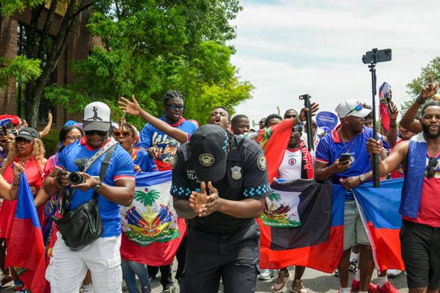 June 24, 2026, Atlanta, Georgia, United States of America: Atlanta Police Officer walking and clapping his hands during the Haiti fan march before the Morocco vs Haiti First Stage Group C match in ATLANTA, Georgia. World Cup 2026: Group C: Morocco : Haiti  - ZUMAg276 20260624_zsp_g276_003 Copyright: xMalachixGabrielx