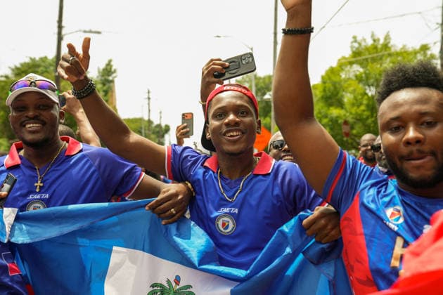 June 24, 2026, Atlanta, Georgia, United States of America: Three Haiti fans holding up the Haitian flag for the cameras during the Haiti fan march before the Morocco vs Haiti First Stage Group C match in ATLANTA, Georgia. Atlanta United States of America - ZUMAg276 20260624_zsp_g276_019 Copyright: xMalachixGabrielx