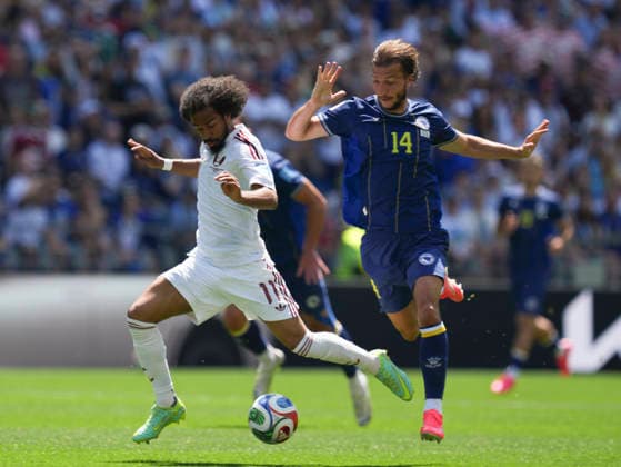 (260625) -- SEATTLE, June 25, 2026 -- Ivan Sunjic (R) of Bosnia and Herzegovina vies with Akram Afif of Qatar during the group B match between Bosnia and Herzegovina and Qatar at the 2026 FIFA World Cup, WM, Weltmeisterschaft, Fussball at Seattle Stadium in Seattle, the United States, June 24, 2026. ) (SP)U.S.-SEATTLE-FOOTBALL-FIFA WORLD CUP-GROUP B-BIH VS QAT PengxZiyang 