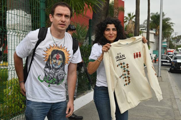 Iranian national team, Nationalteam FIFA World Cup, WM, Weltmeisterschaft, Fussball 2026 leave Mexico camp to Seattle match to face Egypt TIJUANA, MEXICO - JUNE 24: Yalda (right), a Tijuana-based Iranian citizen, who works as a painter, shows off t-shirts she produced for the Iranian National team before their leave from the Marriott Hotel to the Tijuana International Airport upon the team’s departure for Seattle, Washington, where it will play against Egypt on Friday in Tijuana, Mexico, on Wednesday, June 24, 2026, as part of the 2026 World Cup football tournament. (Carlos A. Moreno for Anadolu Images) Carlos Moreno Anadolu Tijuana Mexico. Editorial use only. Please get in touch for any other usage.  Copyright: x2026xAnadoluxCarlosxMorenox