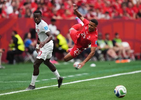 June 24, 2026, Vancouver, Bc, CANADA: Switzerland s Luca Jaquez (25) is upended by Canada s Richie Laryea (22) during the first half of a World Cup Group B soccer match, in Vancouver, on Wednesday, June 24, 2026. Canada News - June 24, 2026  - ZUMAc35_ 20260624_zaf_c35_107 Copyright: xDarrylxDyckx