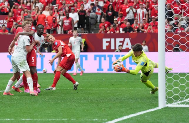 (260625) -- VANCOUVER, June 25, 2026 -- Gregor Kobel (1st R), goalkeeper of Switzerland makes a save during the group B match between Switzerland and Canada at the 2026 FIFA World Cup, WM, Weltmeisterschaft, Fussball at BC Place Vancouver in Vancouver, Canada, June 24, 2026. ) (SP)CANADA-VANCOUVER-FOOTBALL-FIFA WORLD CUP-GROUP B-SUI VS CAN MengxYongmin 