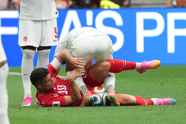 (260625) -- VANCOUVER, June 25, 2026 -- Granit Xhaka (bottom) of Switzerland falls down during the group B match between Switzerland and Canada at the 2026 FIFA World Cup, WM, Weltmeisterschaft, Fussball at BC Place Vancouver in Vancouver, Canada, June 24, 2026. ) (SP)CANADA-VANCOUVER-FOOTBALL-FIFA WORLD CUP-GROUP B-SUI VS CAN MengxYongmin 