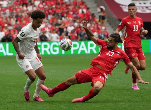 (260625) -- VANCOUVER, June 25, 2026 -- Tajon Buchanan (L) of Canada vies with Ricardo Rodriguez of Switzerland during the group B match between Switzerland and Canada at the 2026 FIFA World Cup, WM, Weltmeisterschaft, Fussball at BC Place Vancouver in Vancouver, Canada, June 24, 2026. ) (SP)CANADA-VANCOUVER-FOOTBALL-FIFA WORLD CUP-GROUP B-SUI VS CAN MengxYongmin 