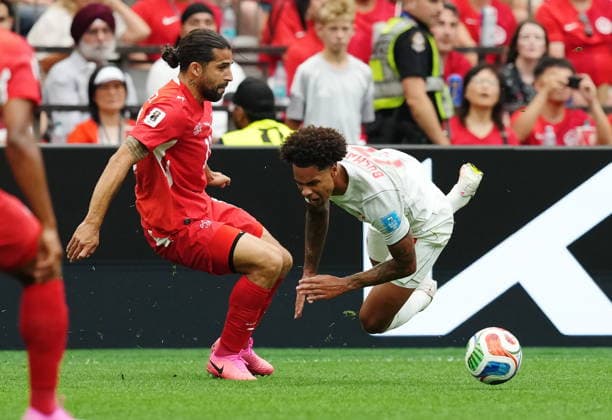 June 24, 2026, Vancouver, Bc, CANADA: Switzerland s Ricardo Rodriguez (left) trips up Canada s Tajon Buchanan (17) during the first half of a World Cup Group B soccer match, in Vancouver, on Wednesday, June 24, 2026. Canada News - June 24, 2026  - ZUMAc35_ 20260624_zaf_c35_114 Copyright: xEthanxCairnsx