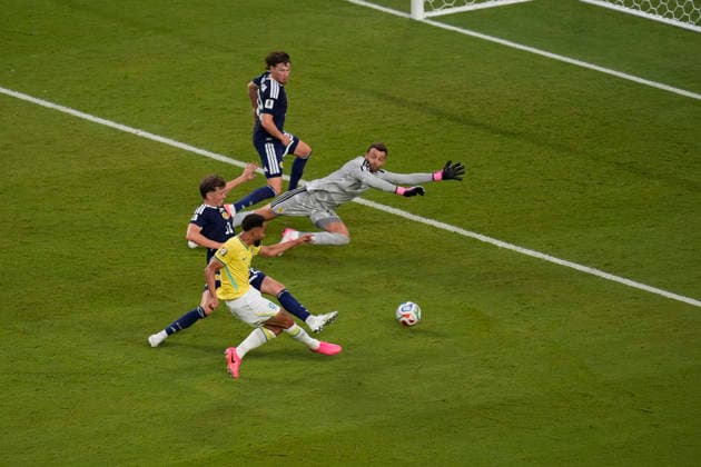 June 24, 2026, Miami Gardens, Florida, USA: Forward Matheus Cunha (9) of Brazil puts the ball past Goalkeeper Angus Gunn (1) of Scotland as he scores the 3rd goal of the game during 2nd half of the World Cup Group C, Round 1 match between Brazil and Scotland at Miami Stadium. Miami Gardens USA - ZUMAd212 20260624_zsp_d212_028 Copyright: xRichardxDolex