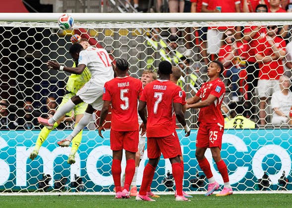 June 24, 2026, Vancouver, British Columbia, Canada: Gregor Kobel 1 of Switzerland punches the ball in front of Tani Oluwaseyi 12 of Canada during the FIFA World Cup, WM, Weltmeisterschaft, Fussball 2026 Group B match between Switzerland and Canada at BC Place Vancouver. World Cup 2026: Group B Switzerland 2:1 Canada  - ZUMAc132 20260624_fap_c132_018 Copyright: xAndrewxChinx