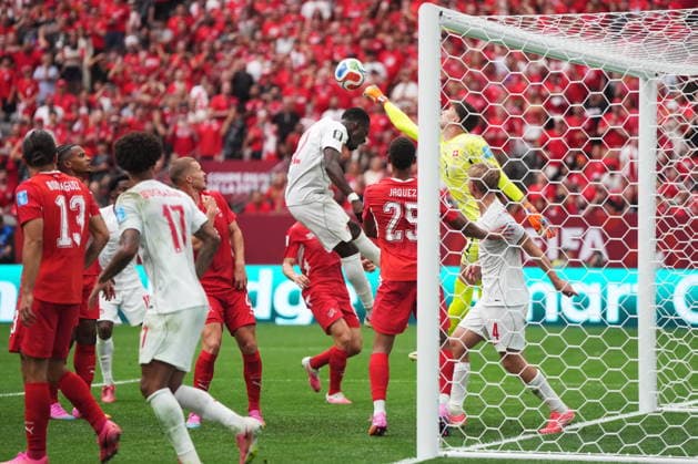 June 24, 2026, Vancouver, Bc, CANADA: Switzerland goalkeeper Gregor Kobel (back right) punches the ball away from Canada s Tani Oluwaseyi (12) during the second half of a World Cup Group B soccer match, in Vancouver, on Wednesday, June 24, 2026. Canada News - June 24, 2026  - ZUMAc35_ 20260624_zaf_c35_215 Copyright: xDarrylxDyckx