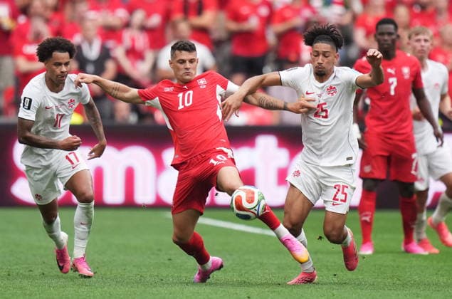 June 24, 2026, Vancouver, Bc, CANADA: Switzerland s Granit Xhaka (10) battles for the ball with Canada s Tajon Buchanan (17) and Nathan-Dylan Saliba (25) during the second half of a World Cup Group B soccer match, in Vancouver, on Wednesday, June 24, 2026. Canada News - June 24, 2026  - ZUMAc35_ 20260624_zaf_c35_218 Copyright: xDarrylxDyckx