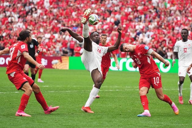 June 24, 2026, Vancouver, Bc, CANADA: Canada s Promise David (24) takes a shot on goal as Switzerland s Granit Xhaka (10) defends during the second half of a World Cup Group B soccer match, in Vancouver, on Wednesday, June 24, 2026. Canada News - June 24, 2026  - ZUMAc35_ 20260624_zaf_c35_235 Copyright: xDarrylxDyckx
