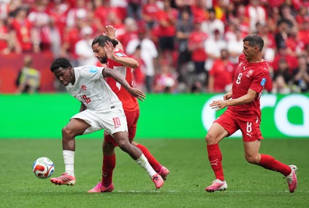 June 24, 2026, Vancouver, Bc, CANADA: Canada s Jonathan David (10) is knocked off the ball by Switzerland s Ricardo Rodriguez (13) as Remo Freuler (8) looks on during the second half of a World Cup Group B soccer match, in Vancouver, on Wednesday, June 24, 2026. Canada News - June 24, 2026  - ZUMAc35_ 20260624_zaf_c35_243 Copyright: xDarrylxDyckx