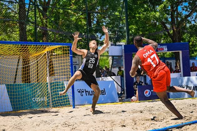 Moritz Ebert ( 26; Deutschland Beachhandball Nationalmannschaft) streckt sich als Torwart mit erhobenen Armen dem Wurf des Oman-Angreifers ( 17) entgegen. Die Szene findet im Sand vor dem deutschen Tor bei der Beach Handball World Championship, WM, Weltmeisterschaft in Zagreb statt. IHF Beach Handball World Championship 2026, 23.06.2026, Zagreb, Jarun See *** Moritz Ebert, No. 26, of the German national beach handball team, stretches out as a goalkeeper with his arms raised to block a shot by Oman’s No. 17 attacker. The scene takes place on the sand in front of the German goal at the Beach Handball World Championship in Zagreb. IHF Beach Handball World Championship 2026, June 23, 2026, Zagreb, Lake Jarun Copyright: xspeedshotx xDorianfrickx
